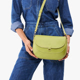 All Variants | Model holding large Monaco Crossbody in Wasabi