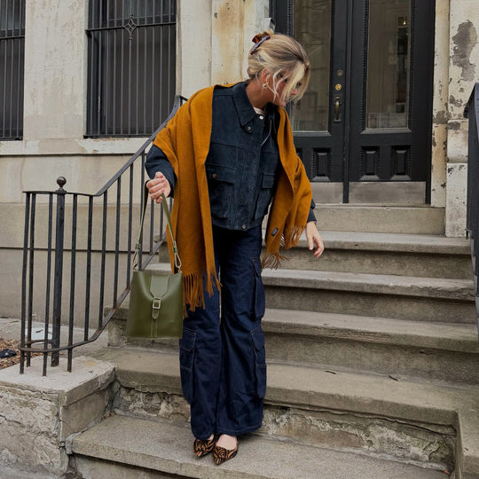 person standing on steps with PLG bag in hands