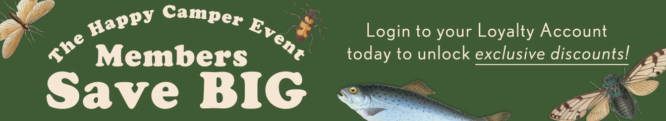 A green promotional banner with the text 'The Happy Camper Event Members Save BIG' in large cream lettering, plus a fish illustration and the message 'Login to your Loyalty Account today to unlock exclusive discounts!' in white text.