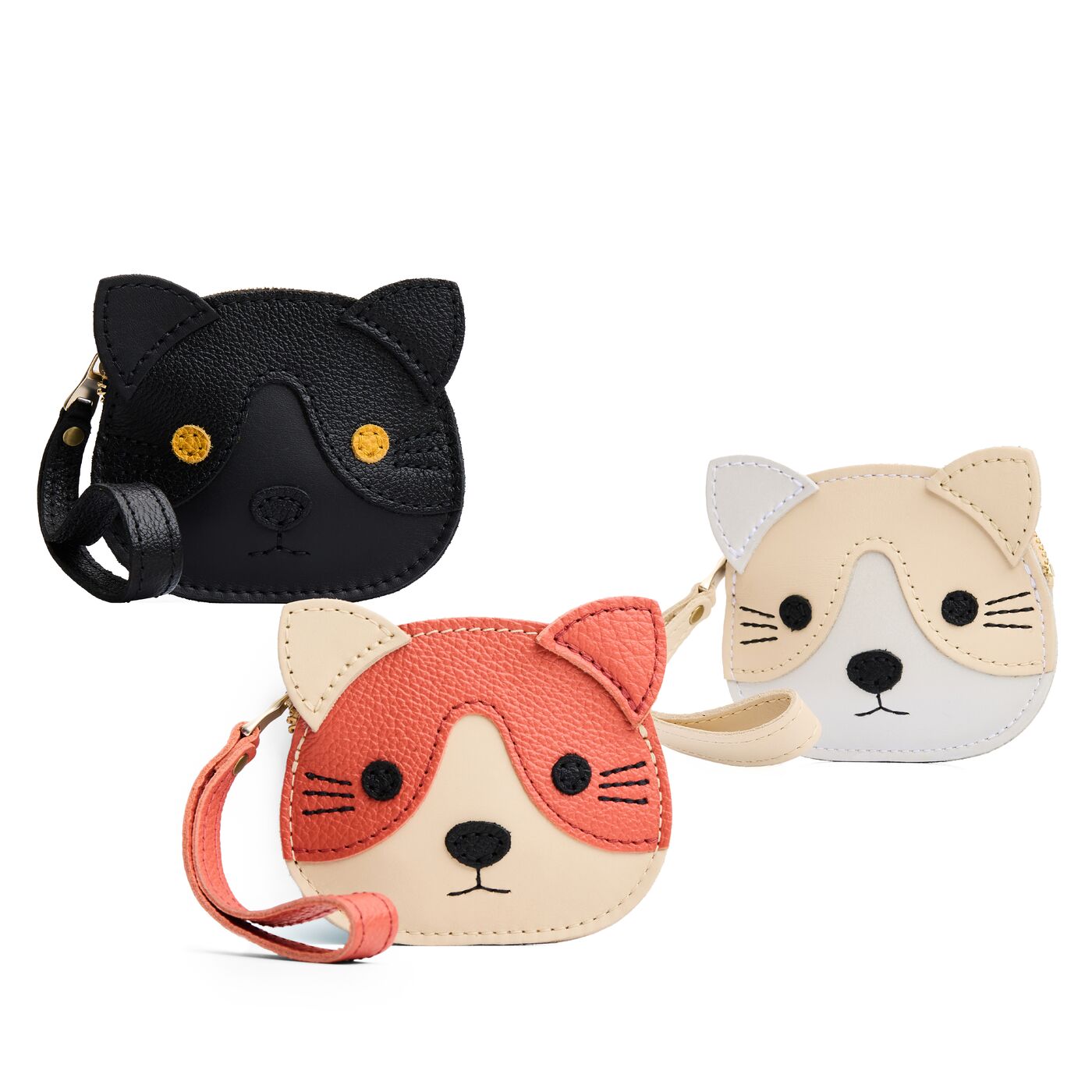 All Variants | Three small cat-shaped leather pouches with embroidered facial details and a wrist strap.
