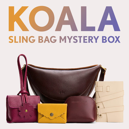 Koala Sling Bag in Coldbrew next to Blooming Wristlet, Daisy Plus Wallet, Luna Pouch, and Leather Wrap Journal. Text reads "Koala Sling Bag Myster Box"