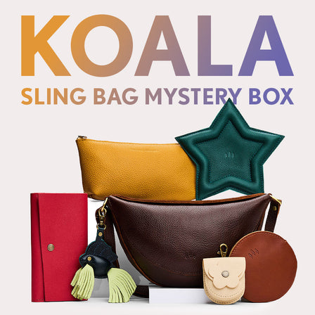 Koala Sling Bag in Coldbrew next to Rancher Wallet, Utility Bag, Betta Fish Keychain, Stellar Trinket Tray, Petunia Pouch, and Gordita Pouch. Text reads "Koala Sling Bag Mystery Box"