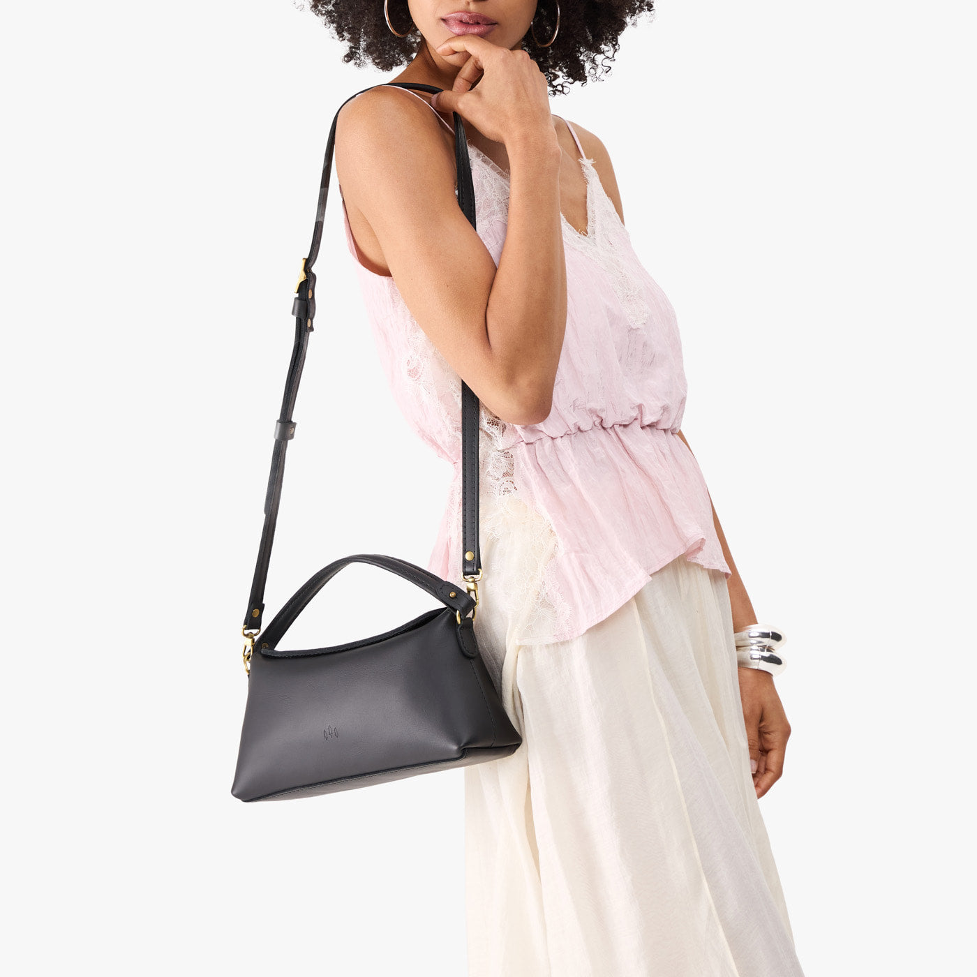 Black | Model holding a black colored bowler style hand bag