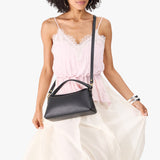 Black | Model holding a black colored bowler style hand bag