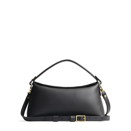 Black | Leather bowler bag with magnetic closure against a white background