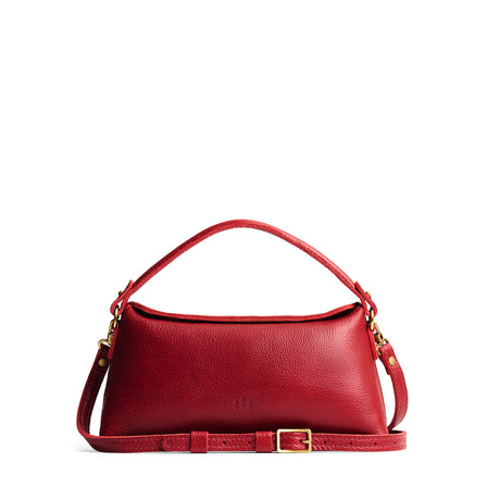 Chili Red | Leather bowler bag with magnetic closure against a white background