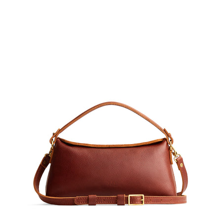 Nutmeg | Leather bowler bag with magnetic closure against a white background