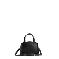Black*Mini | Leather tote bag with handles, adjustable crossbody strap, zipper top, and a back pocket