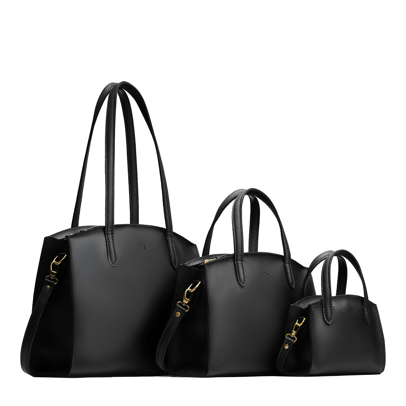 Black | Size comparison image of Mini, Medium, and Large-sized leather tote bags with handles, adjustable crossbody strap, zipper top, and back pockets