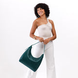 Sea Glass Large | Model holding u-shaped, flat-bottomed leather shoulder bag with adjustable strap