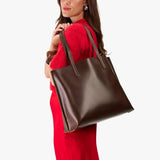 Chocolate Brown Large | Model holding leather tote bag with interior snap key loop