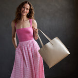 Jasmine | Model holding white tote bag with debossed floral design