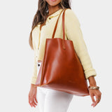 Madrone Large | Model holding leather tote bag with interior snap key loop