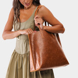 Meadow Large | Model holding leather tote bag with interior snap key loop
