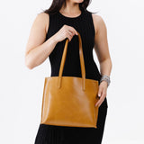 Mango Medium | Model holding leather tote bag with interior snap key loop