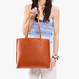 Sienna Medium | Model holding leather tote bag with matching leather handles