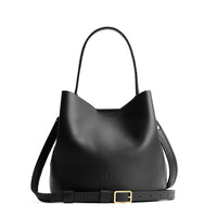 Black*Small | Symmetrical bucket bag with handle, latch closure, and removable crossbody strap
