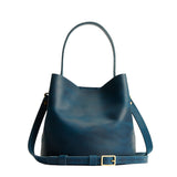 Westward Blue Small | Symmetrical bucket bag with handle, latch closure, and removable crossbody strap