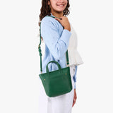 Bacalar | A young model wearing a petite crossbody tote bag with zipper closure and front pocket