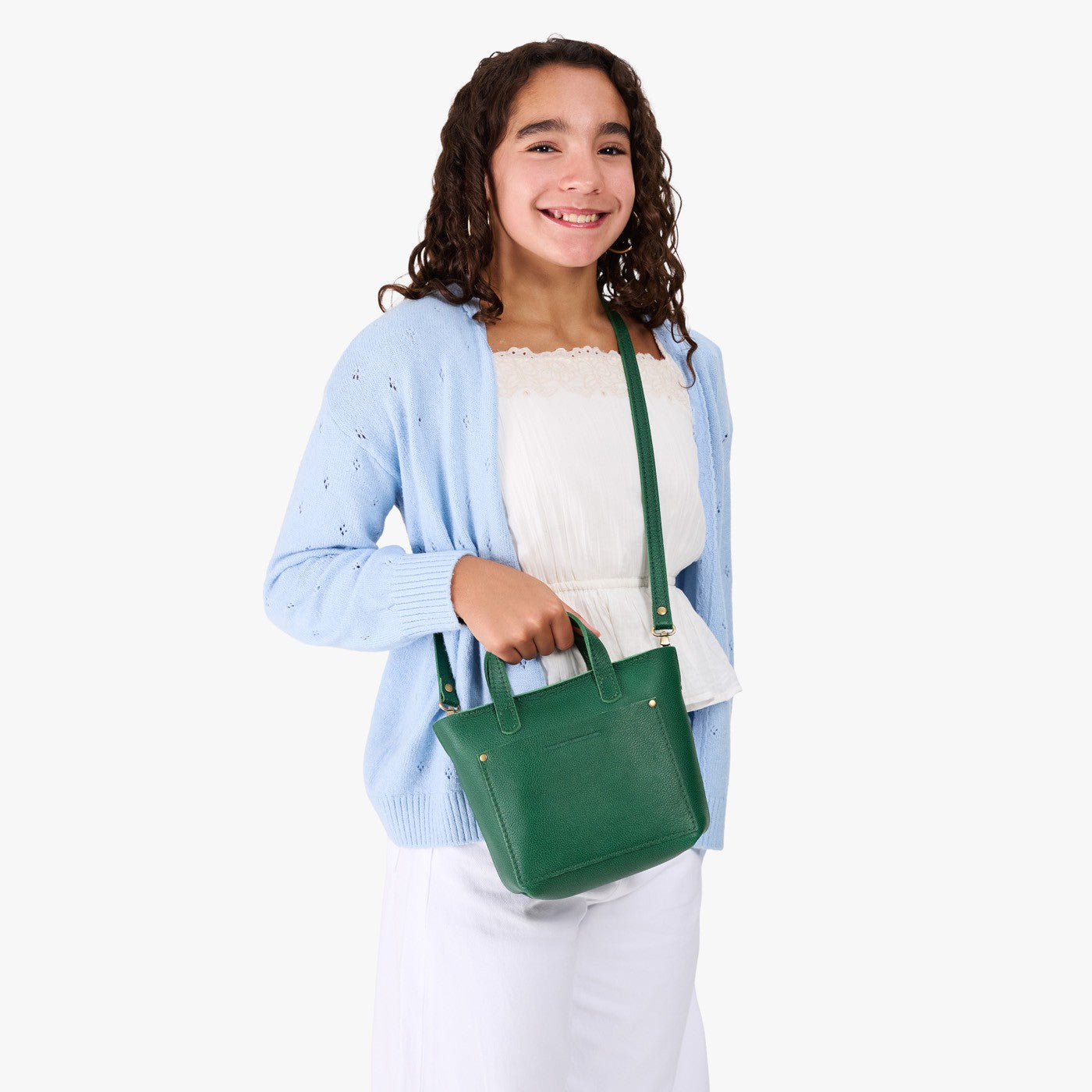 Bacalar | A young model wearing a petite crossbody tote bag with zipper closure and front pocket
