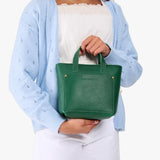 Bacalar | A young model wearing a petite crossbody tote bag with zipper closure and front pocket