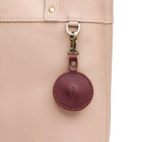 Cognac | Circle-shaped airtag holder keychain with a swivel lobster clasp on bag