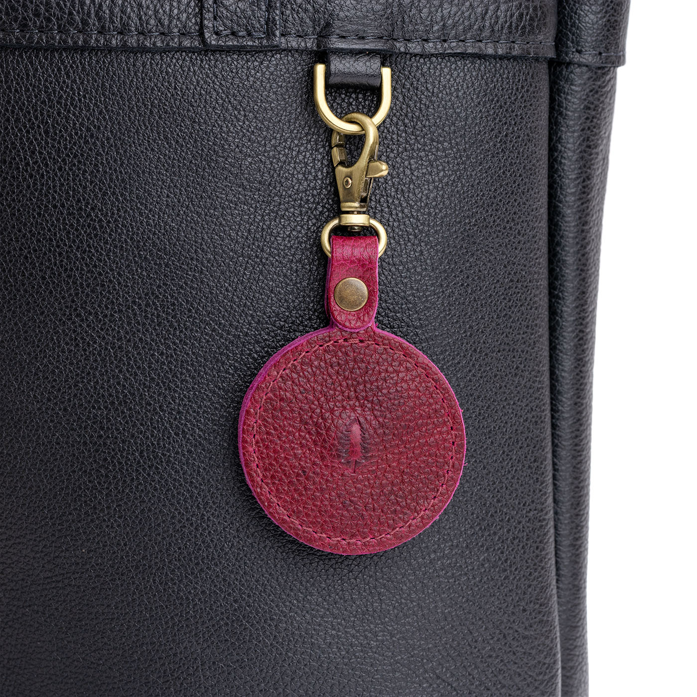 Orchid | Heart-shaped airtag holder keychain with a swivel lobster clasp on bag