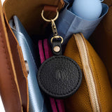 Pebbled--black | Circle-shaped airtag holder keychain with a swivel lobster clasp