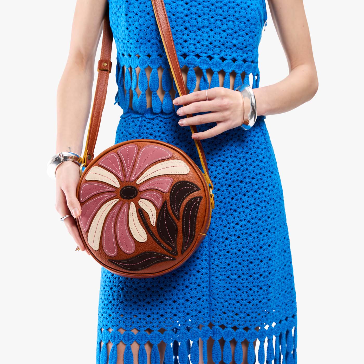 Wildflower Sienna*Large | Model holding circle shaped crossbody bag with top zipper