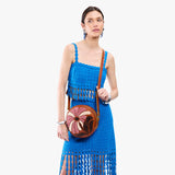 Wildflower Sienna Large | Model wearing circle shaped crossbody bag with top zipper