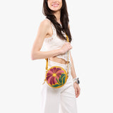 Wildflower Sunshine Small | Model wearing circle shaped crossbody bag with top zipper