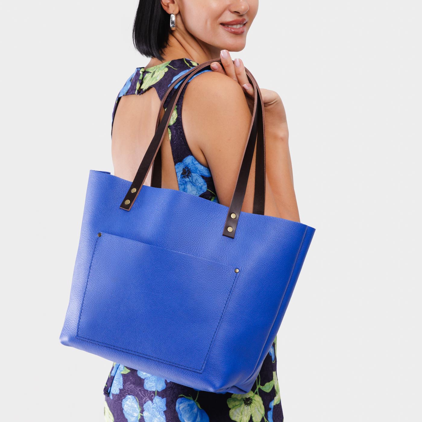 Astro Blue*Classic | Model wearing large leather tote bag with sturdy bridle handles and front pocket