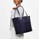 Velvet Blue Classic | Model holding large leather tote bag with sturdy bridle handles and front pocket