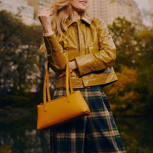 Model wearing a Sunflower Amelie Shoulder Bag in a city park 