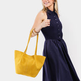 Hello Yellow Large | Model holding wide bucket shaped tote bag with matching leather handles