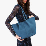 Mariner Blue Large | Model holding a  leather tote bag 