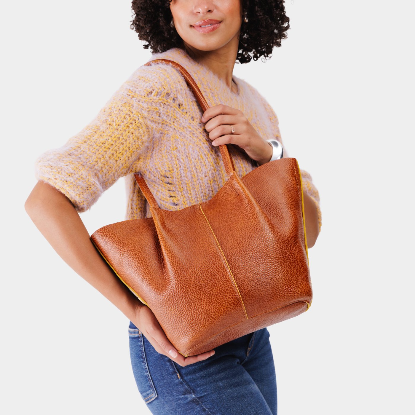 Sienna*Large | Model holding a brown leather tote bag 
