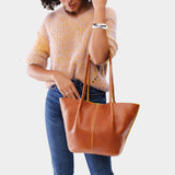 Sienna Large | Model holding wide bucket shaped tote bag with matching leather handles