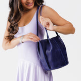 Cobalt Classic | Model holding petite bucket shaped tote bag with matching leather handles