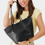 Black Large | Model holding wide bucket shaped tote bag with matching leather handles VARIANT2