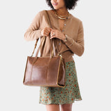 Asheville East/West | Model wearing structured wide tote bag with overlapping panels and crossbody strap