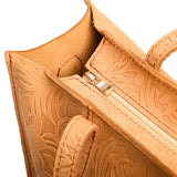 Desert Flower | Close-up of zipper top on structured wide embossed leather tote bag with overlapping panels and crossbody strap