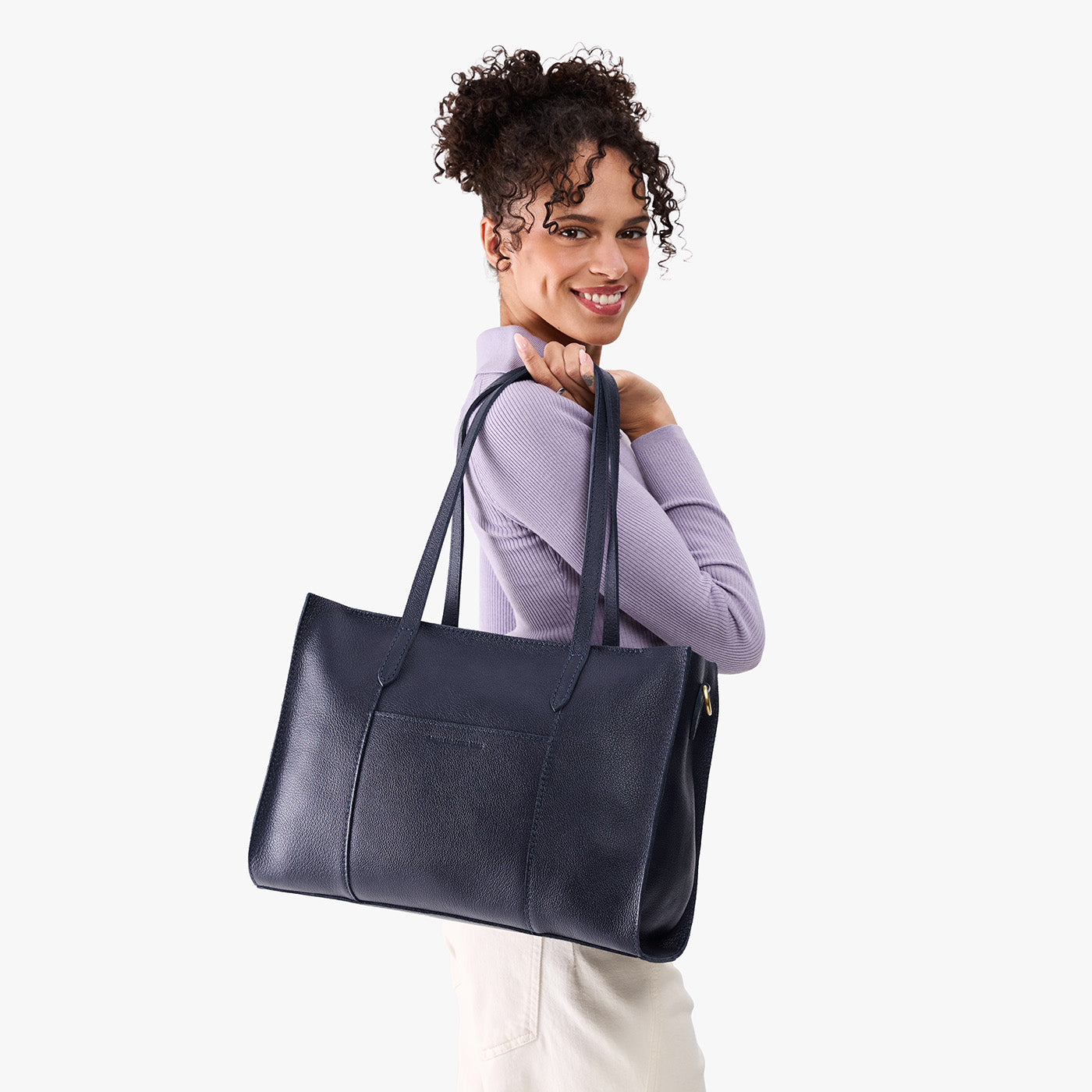 Night Owl*Oversized East/West | Model holding structured wide tote bag with overlapping panels and crossbody strap