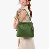 Cactus Large | Model holding symmetrical leather bag with leather drawstring closure and adjustable shoulder strap
