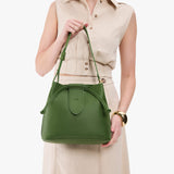 Cactus Large | Model holding symmetrical leather bag with leather drawstring closure and adjustable shoulder strap