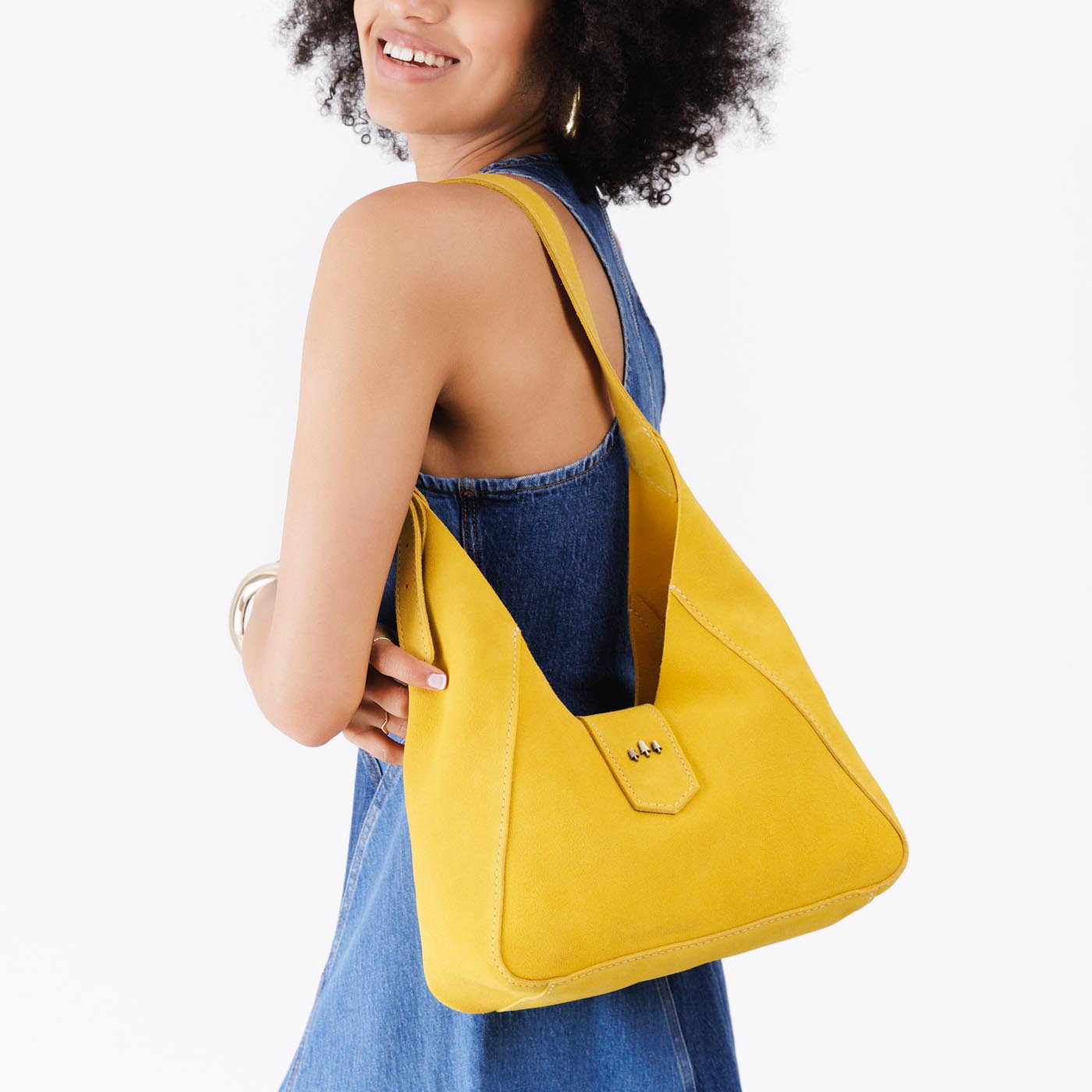Hello Yellow | Model wearing structured hobo shoulder bag with adjustable strap and magnetic closure