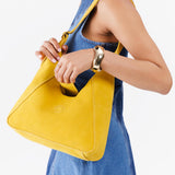 Hello Yellow | Model wearing structured hobo shoulder bag with adjustable strap and magnetic closure