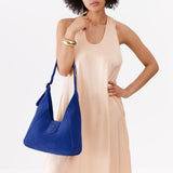 Joni Blue | Model wearing structured hobo shoulder bag with adjustable strap and magnetic closure