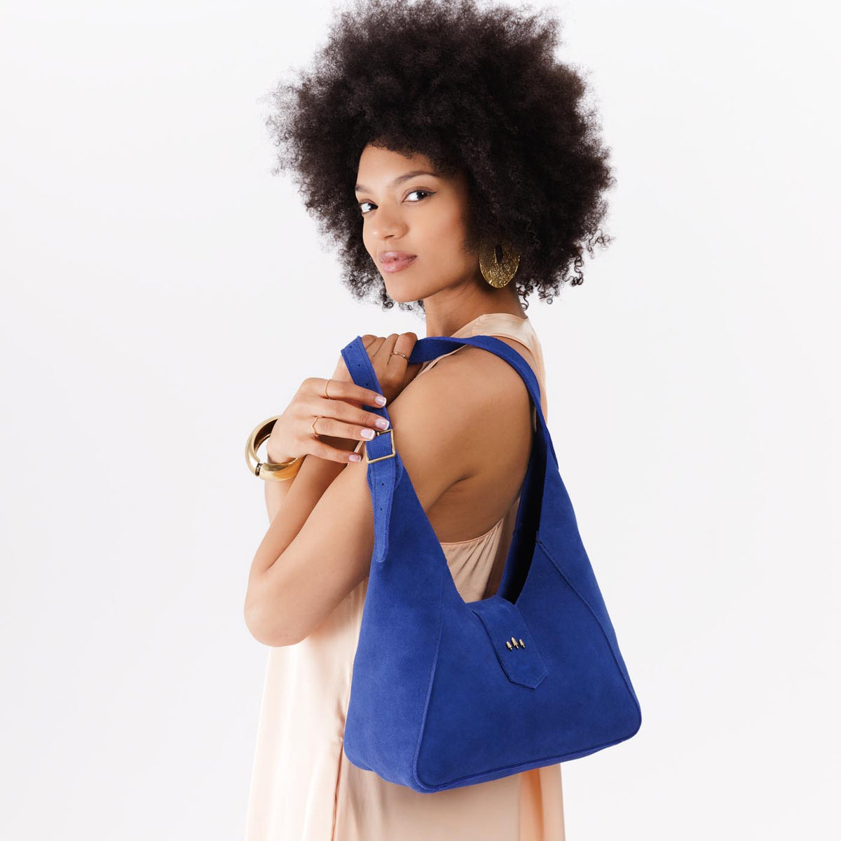 Joni Blue | Model wearing structured hobo shoulder bag with adjustable strap and magnetic closure