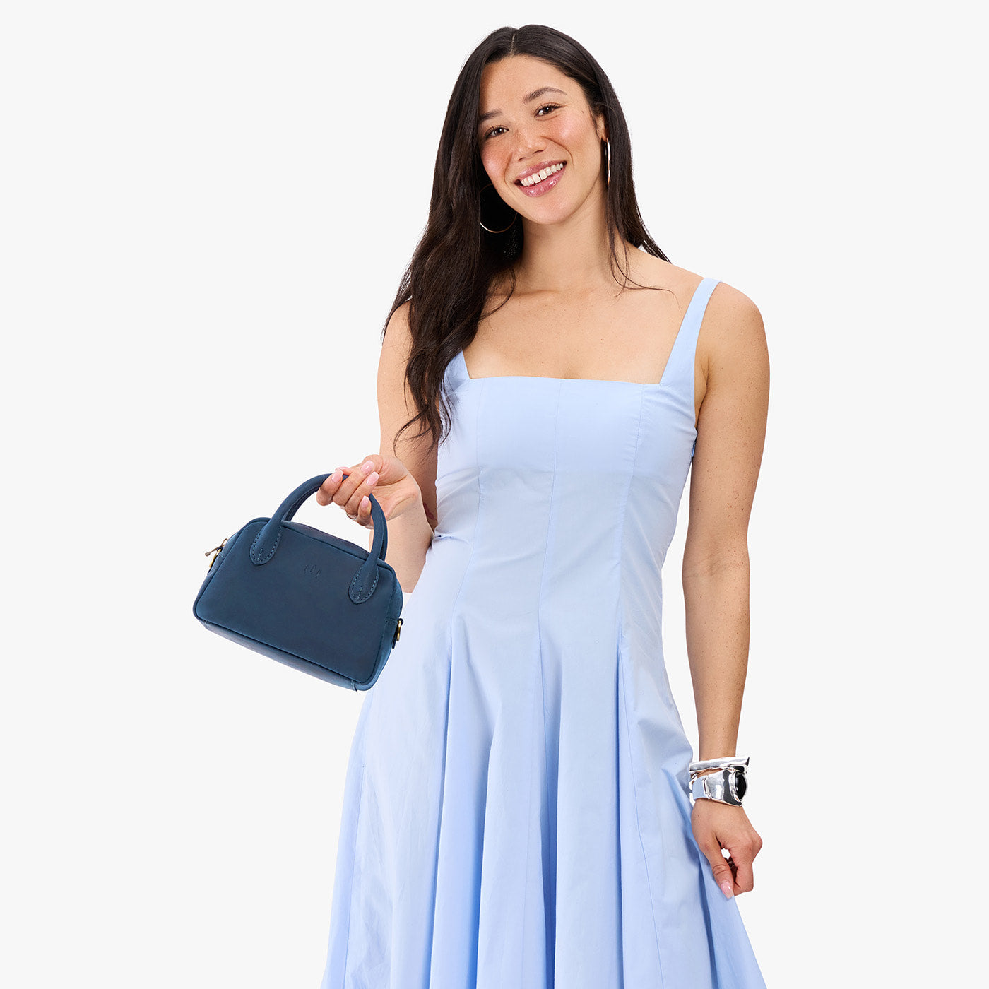 Deep Water*Small | A bowler styled bag being held by a model in a light blue dress
